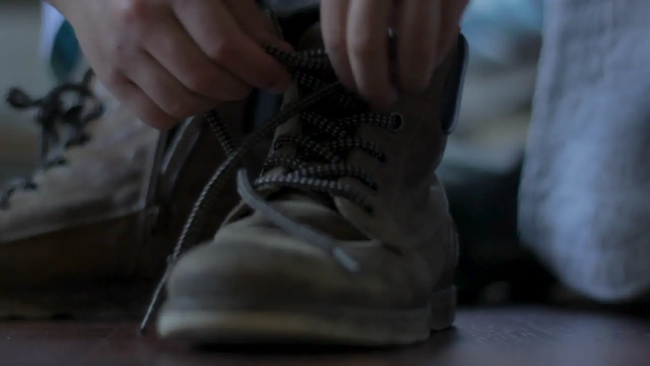 Laces of workers boot being pulled tight