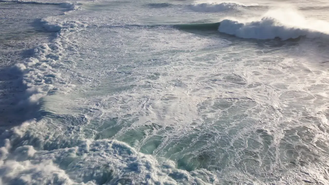 An aerial view of the raging and foaming waves of the Atlantic rolling in all directions