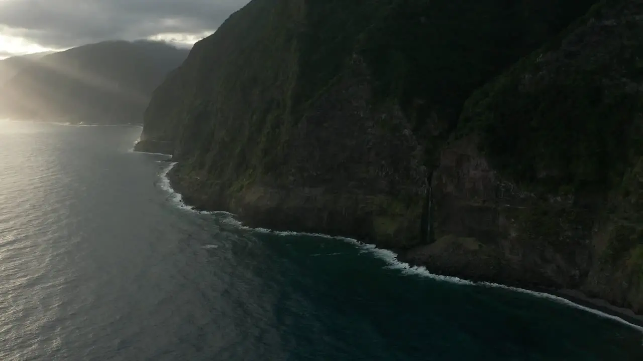 Dramatic scenery at rugged coast of Madeira island with light rays from sunrise