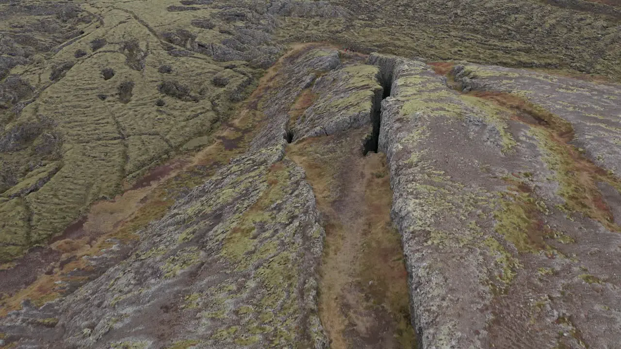 Aerial of open solid lava field in Iceland rugged terrain of earth