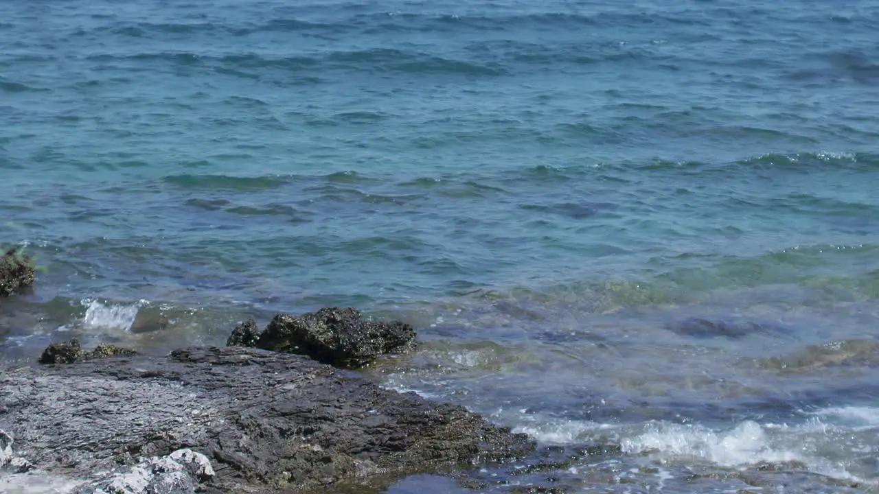 Waves crushing on the rocks on the beach in slow motion