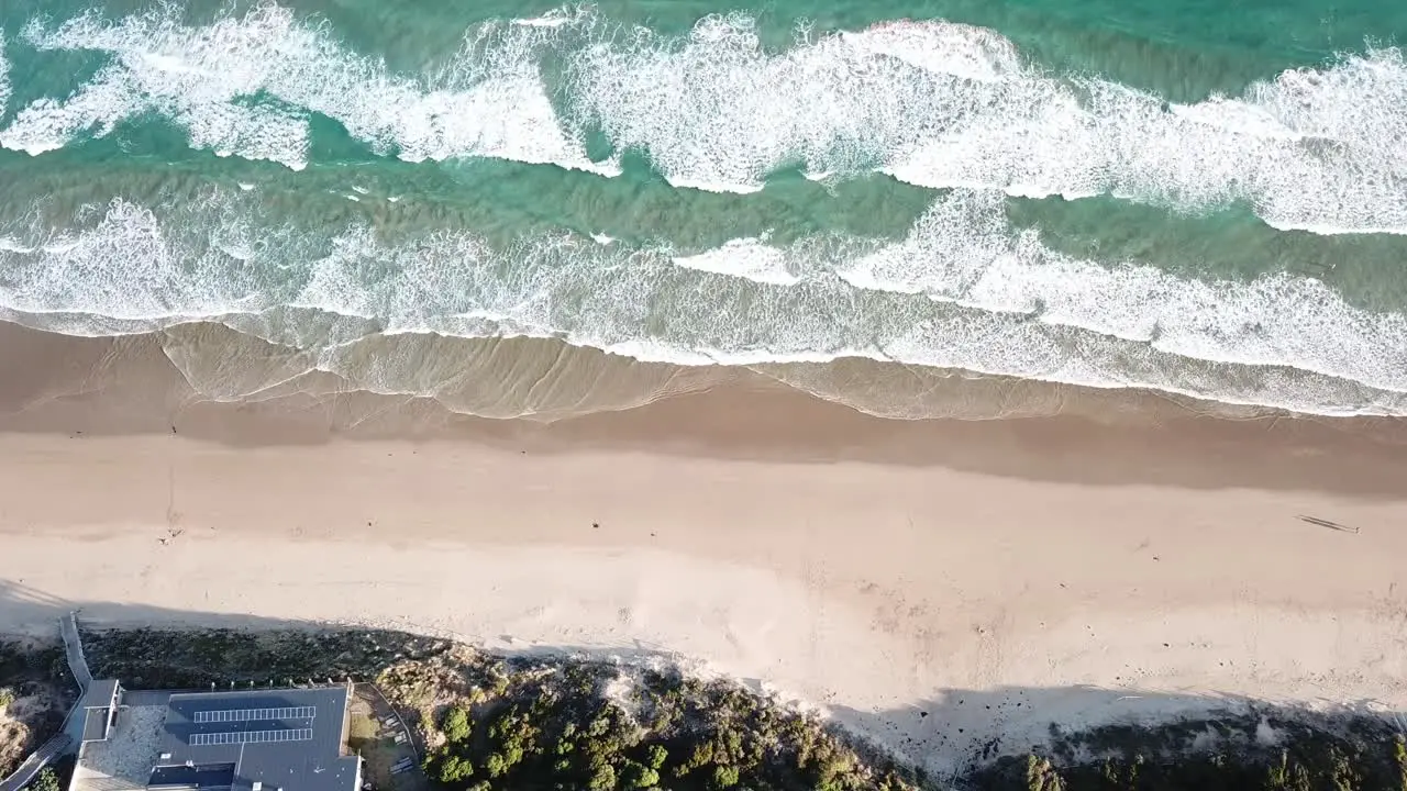 Drone arial high over blue sandy beach on the great ocean road on sunny summers day