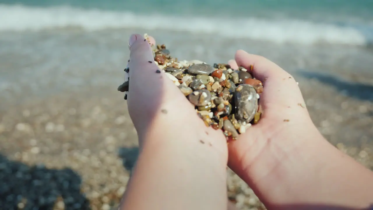 Female Hands Hold A Handful Of Wet Pebbles Rest On The Sea Meditation Concept 4k Video