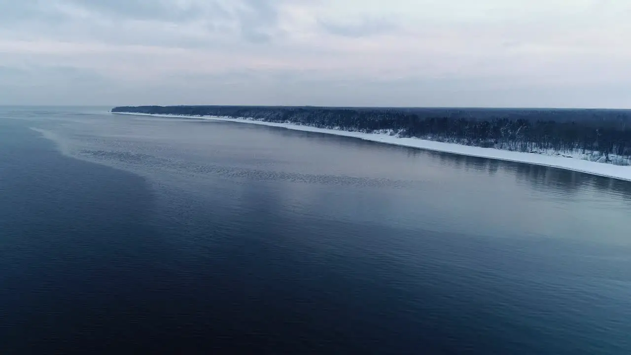 Frozen snowy seashore on a cold winter day