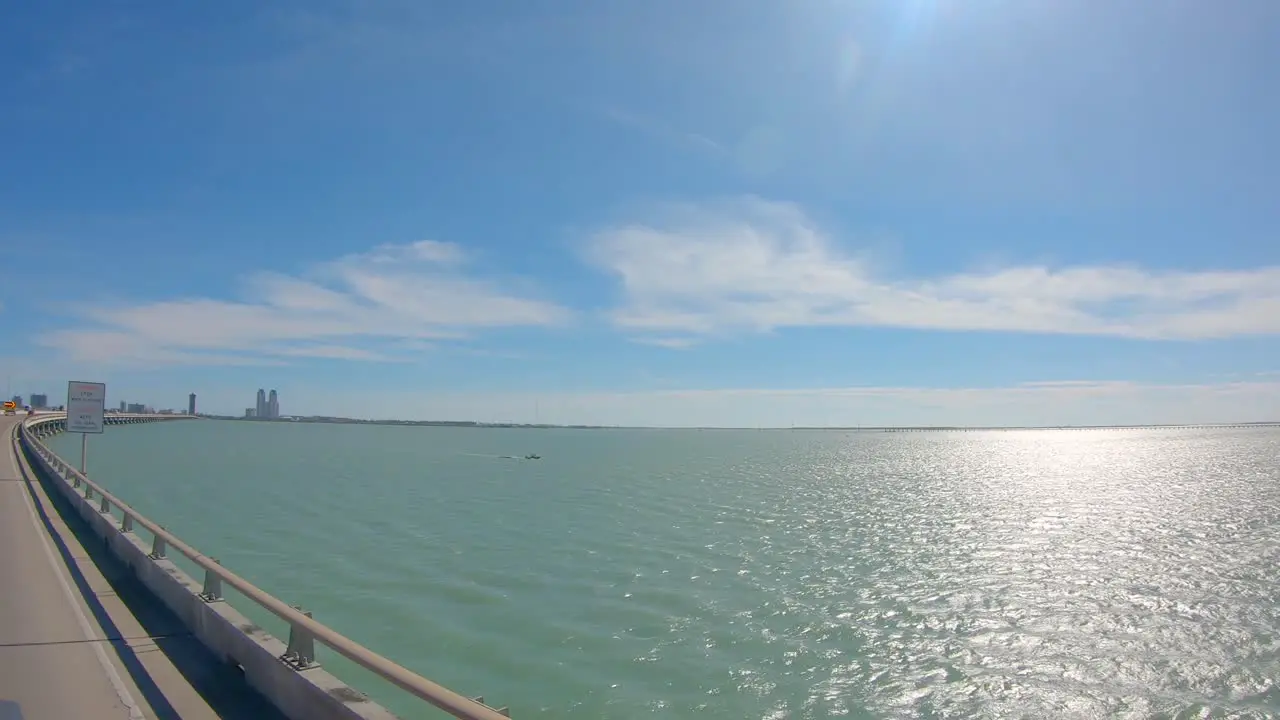 POV out the passengers window while driving on Queen Isabella Causeway over the Laguna Madre at South Padre Island Texas