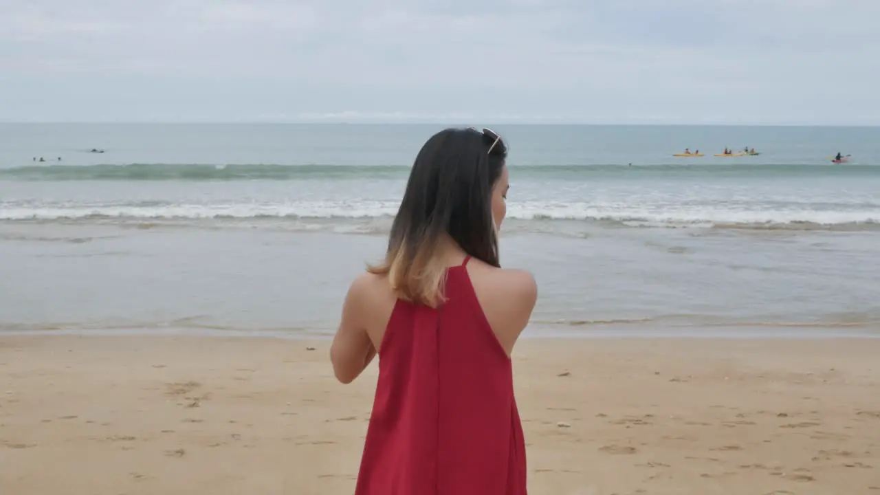 A young asian woman walk on the beach and relax while on holiday vacation