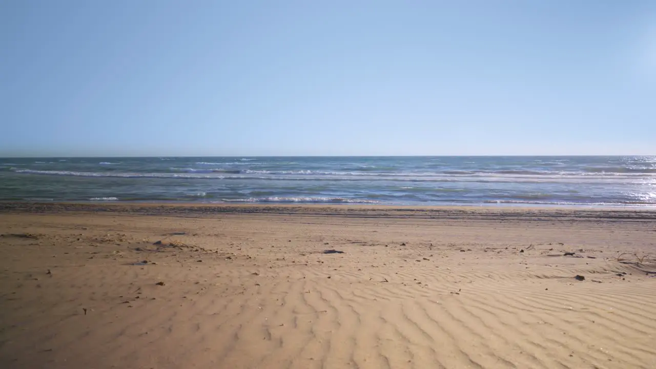 Empty beach with clear blues skies