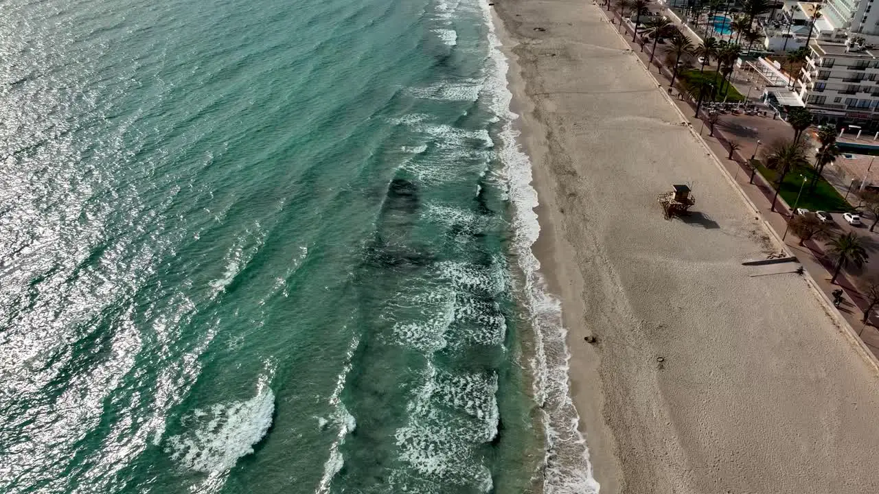 Fly over beach with waves