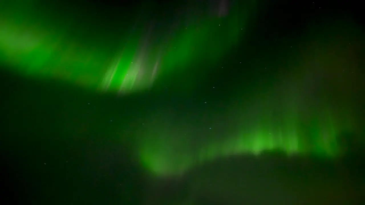 Fast moving green colored aurora Borealis at dark sky over Iceland Island at night Handheld bottom up