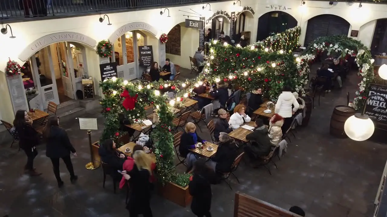 Walking around Covent Garden during the Christmas period in London in December 2022 and showing how busy the location is with tourists and diners in the evening during this festive period