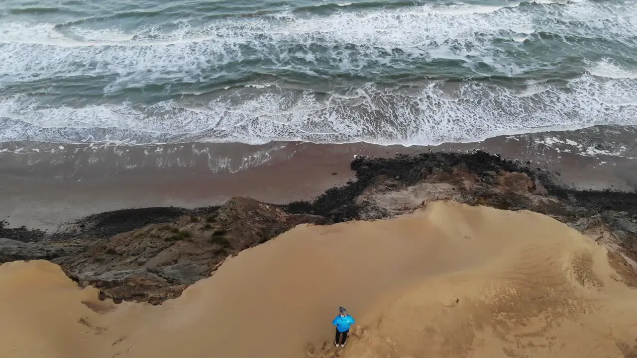 A man standing on high dunes