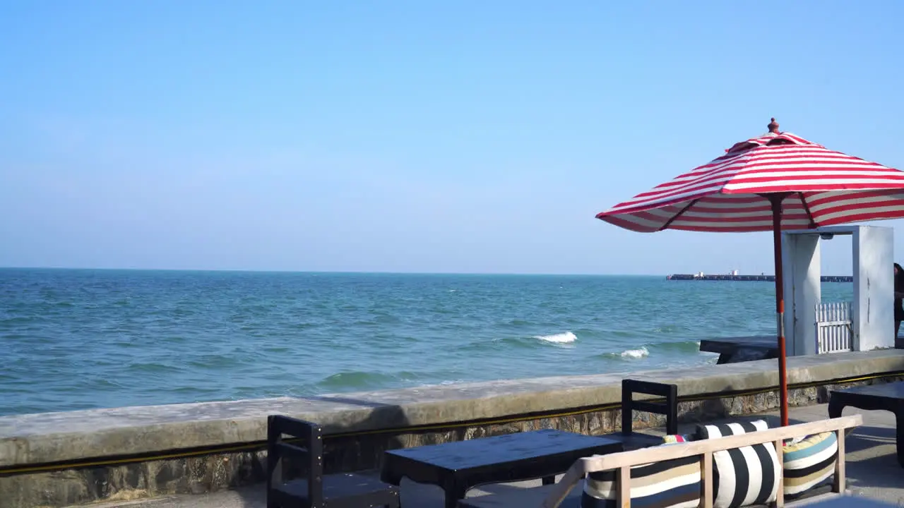 empty bench sofa with umbrella and ocean sea background holiday and vacation concept