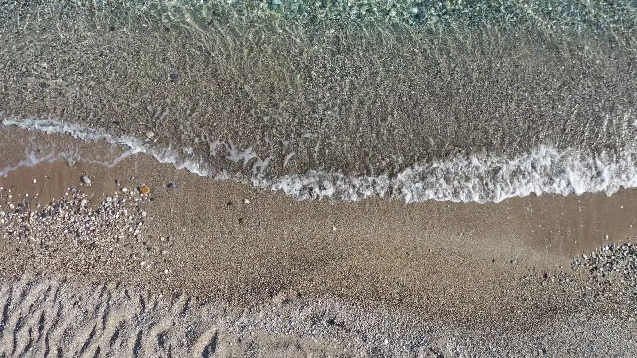 Top Down Aerial View of Mediterranean Sea Waves Breaking on Sandy Beach High Angle Drone Shot