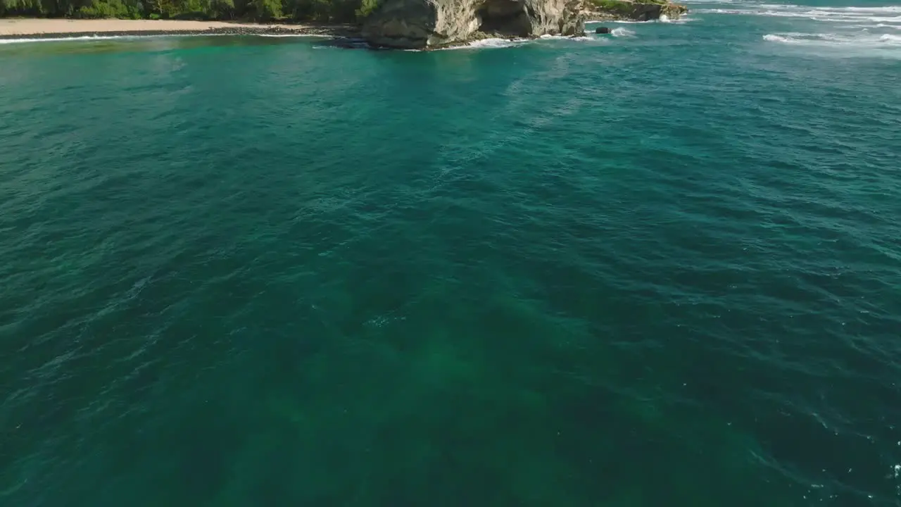 Aerial Move in to reveal cliff at Shipwreck Beach Hawaii