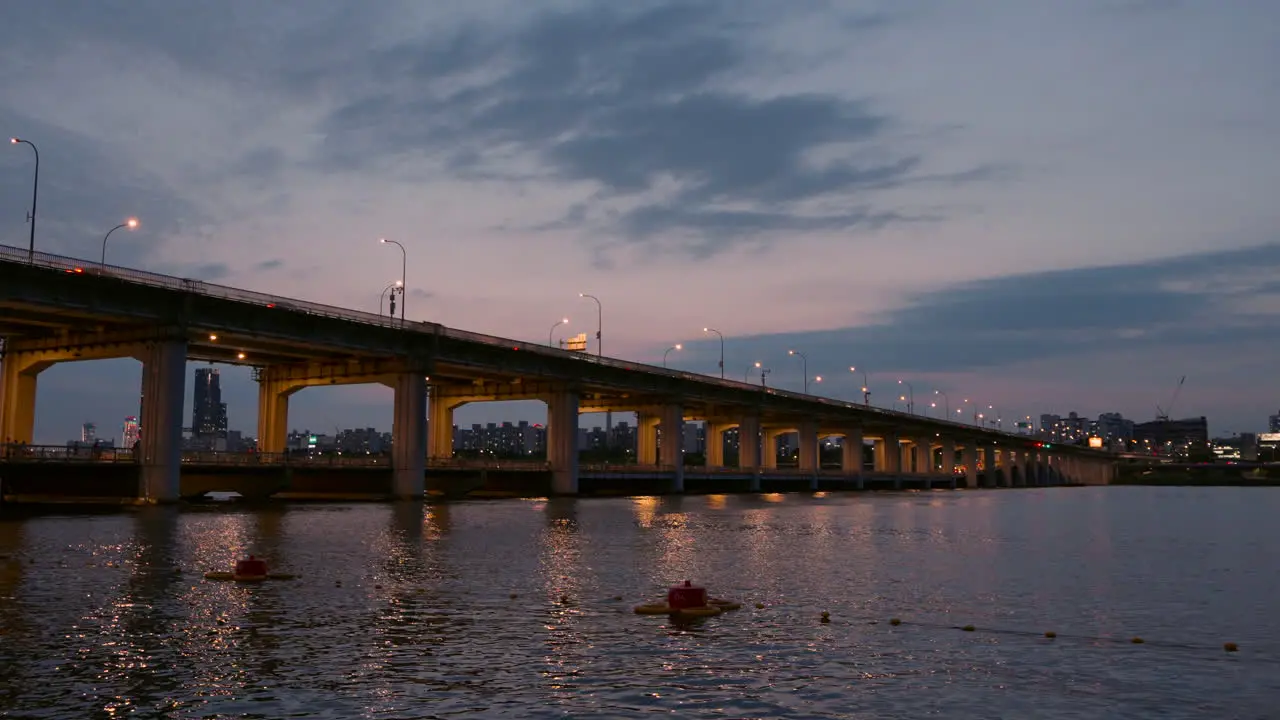 Night Illumination and Cars Traffic on Banpo Bridge over Han River At Stunning Sunset Sunlight Reflections in Water static realtime