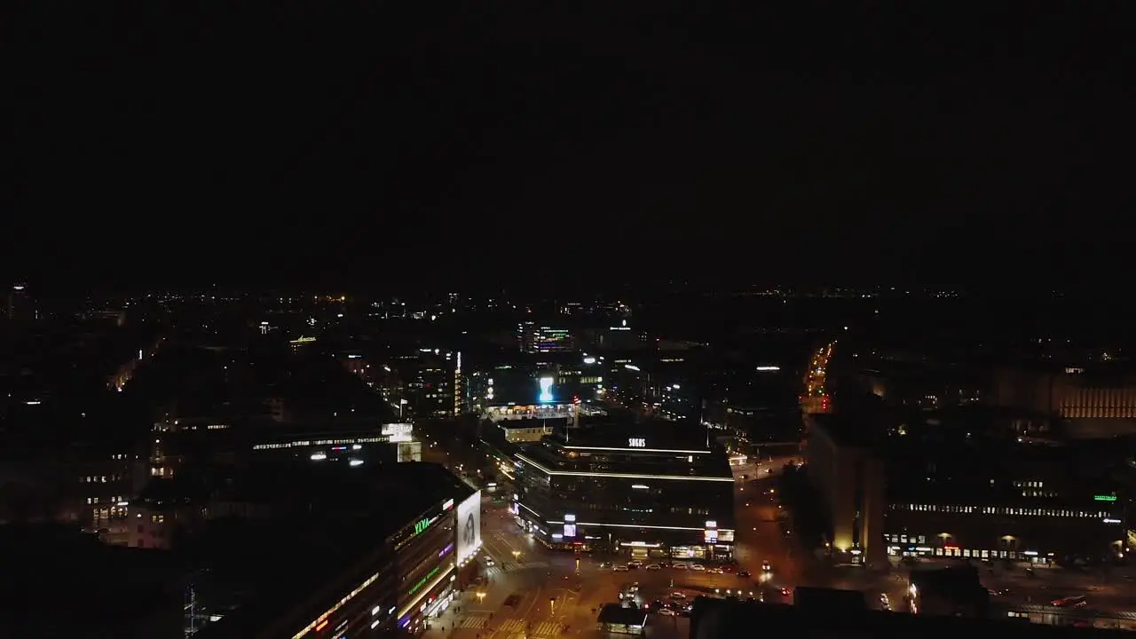 Bright lights of Helsinki retail district on dark black night aerial