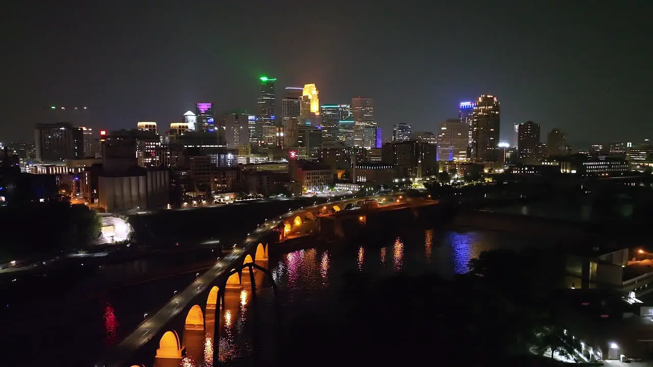 Minneapolis illuminated city skyline view night aerial over Mississippi river