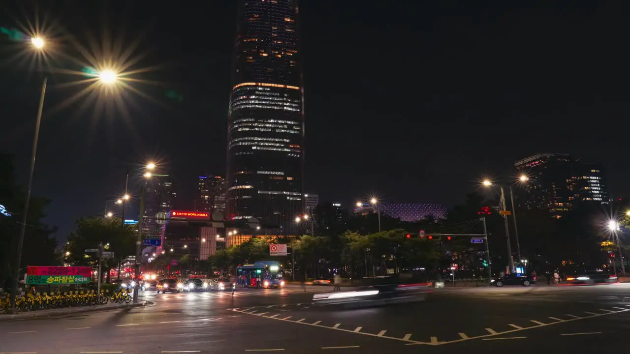 Busy Night streets with cars traffic near Lotte World Tower Mall in Seoul zoom out timelapse