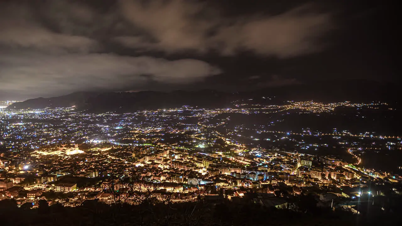 High angle shot over dark Palermo downtown at nigh time with beautiful night city lights in Sicily Italy in timelapse