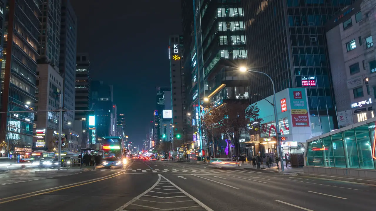 Timelapse Cars Moving Both Sides in Gangnam Street at Night Near Bus Station Boarding Area Road Center View