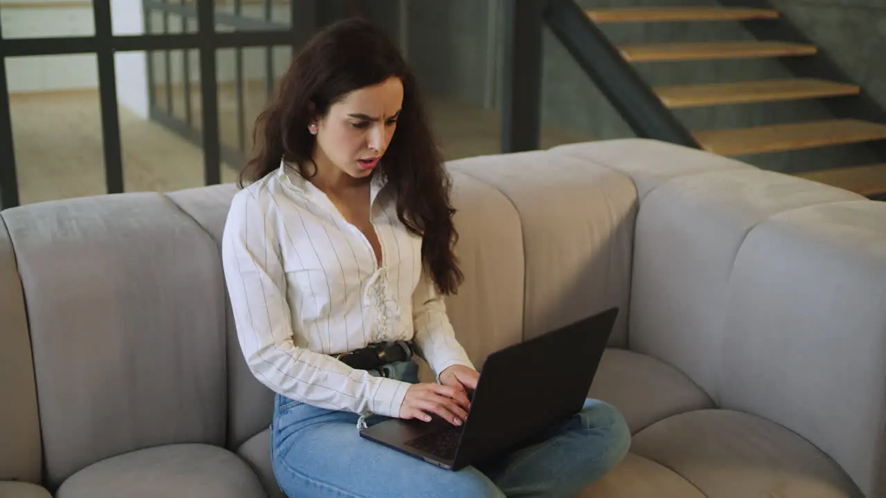 Portrait of upset woman working computer at home in slow motion