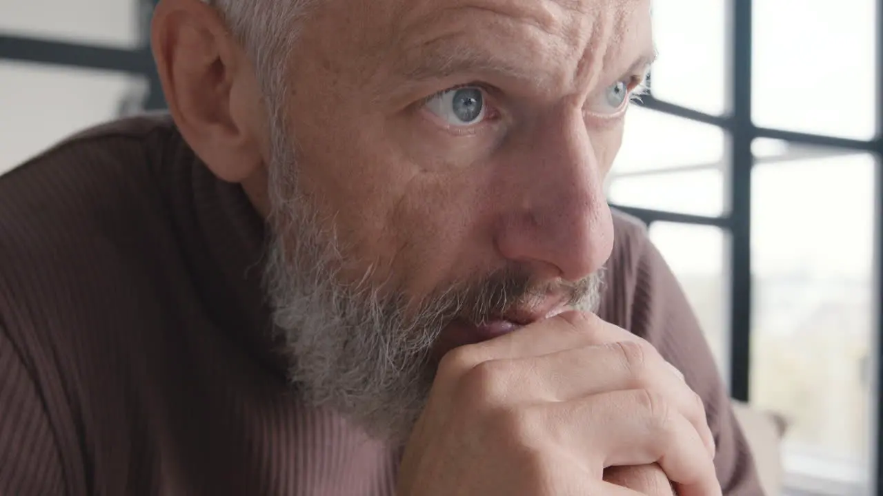 Close Up Of An Upset Middle Aged Man Worrying And Thinking About Something While Sitting On Sofa At Home 1