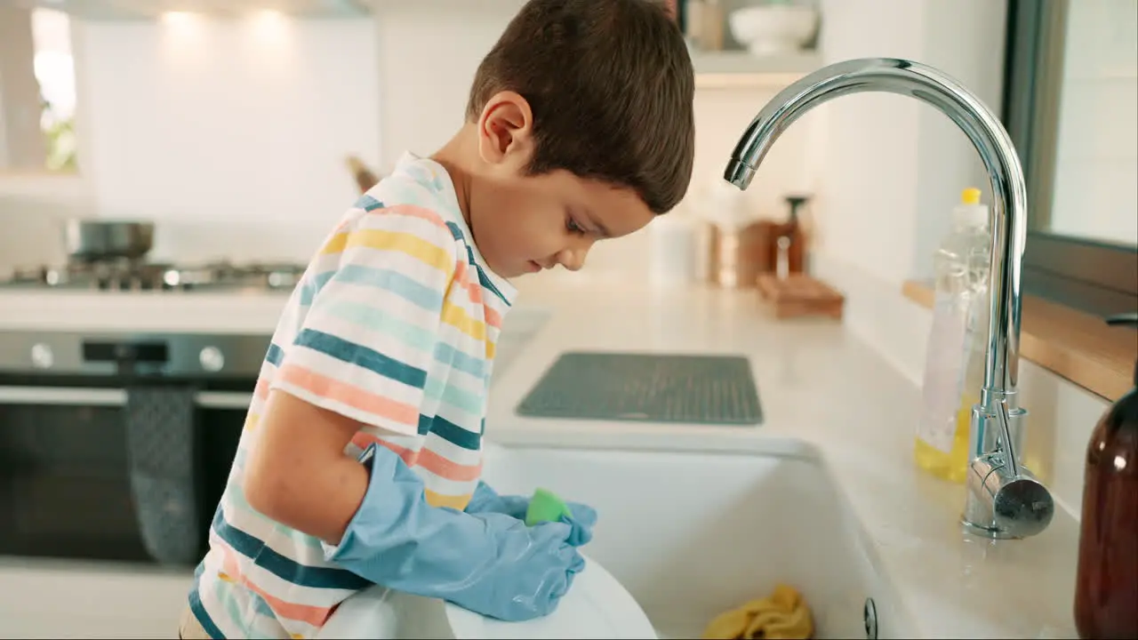 Learning washing dishes or kid with dirty plate