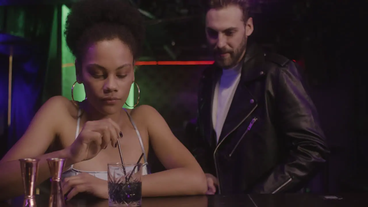 Beautiful Girl Sitting At Bar Counter While Man Coming And Sitting Next To Her