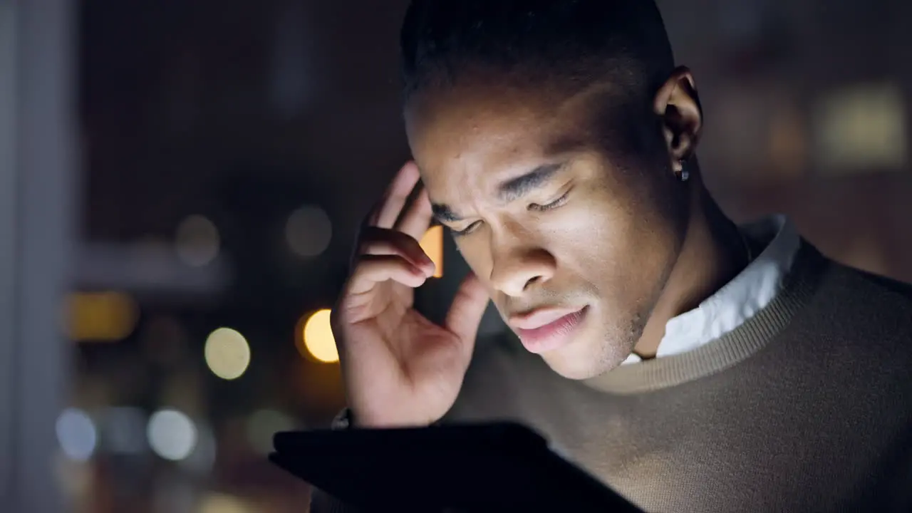 Thinking tablet and face of black man at night