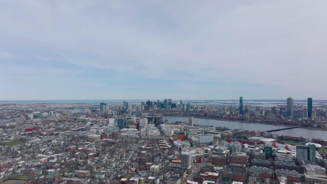 Aerial panoramic footage of metropolis at twilight Backwards reveal buildings in urban neighbourhood Boston USA