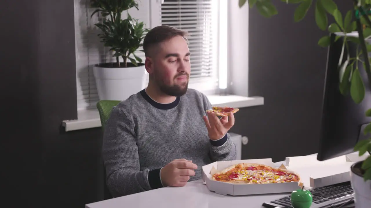 Hungry Man Having A Break And Eating Tasty Pizza At Office