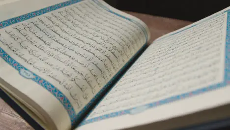 A Handheld Shot of the Quran Religious Text Pages