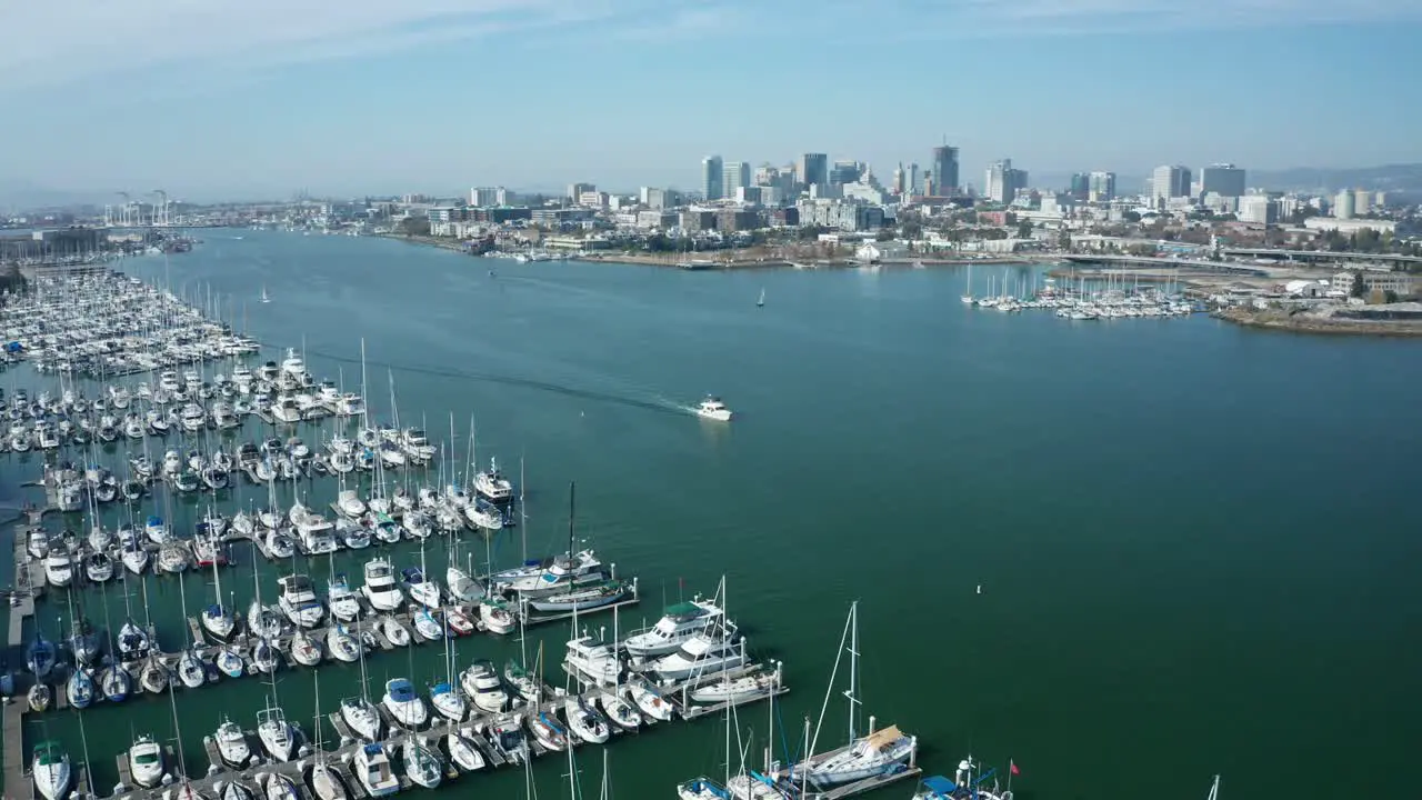 A very large estuary with a marina and hundreds of sailboats on a sunny day in the bay