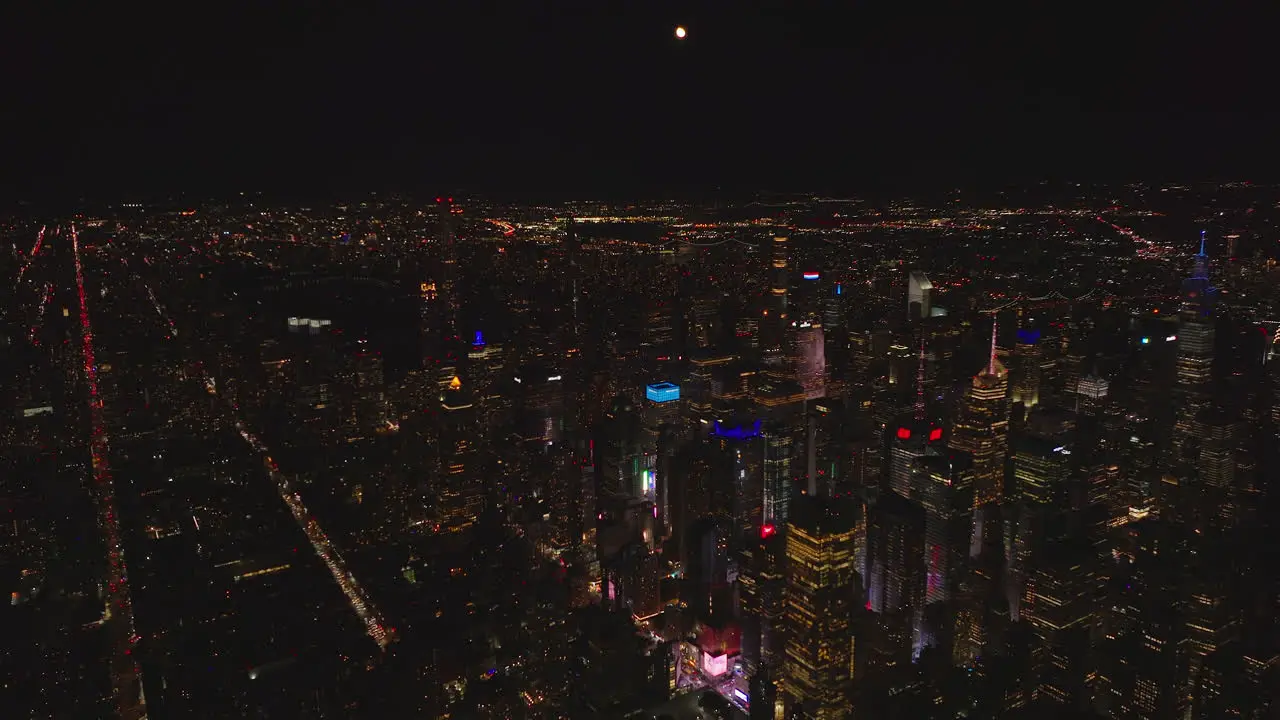 aerial panoramic view of downtown skyscrapers at night Long straight streets with car lights Manhattan New York City USA