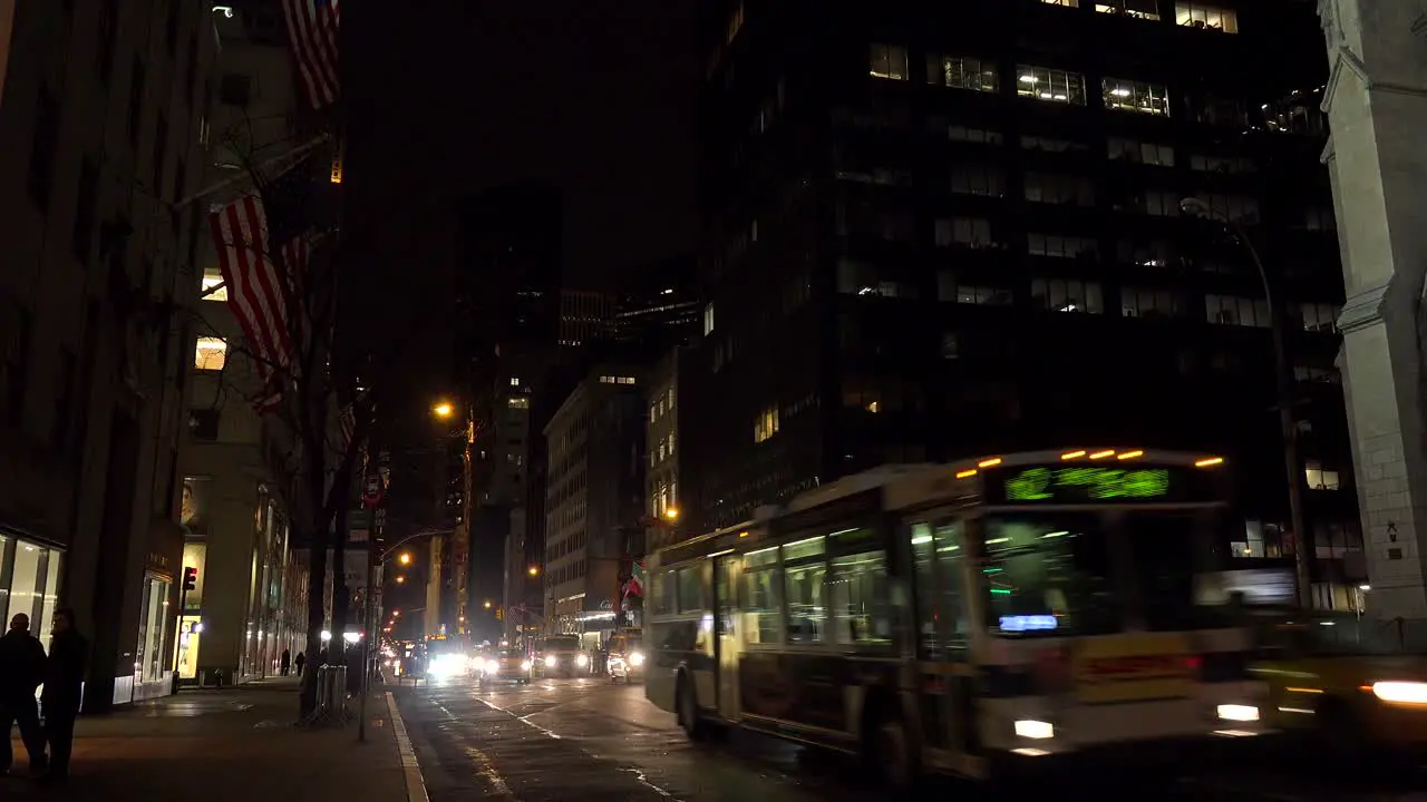 Traffic moves along New York's Fifth Ave at night