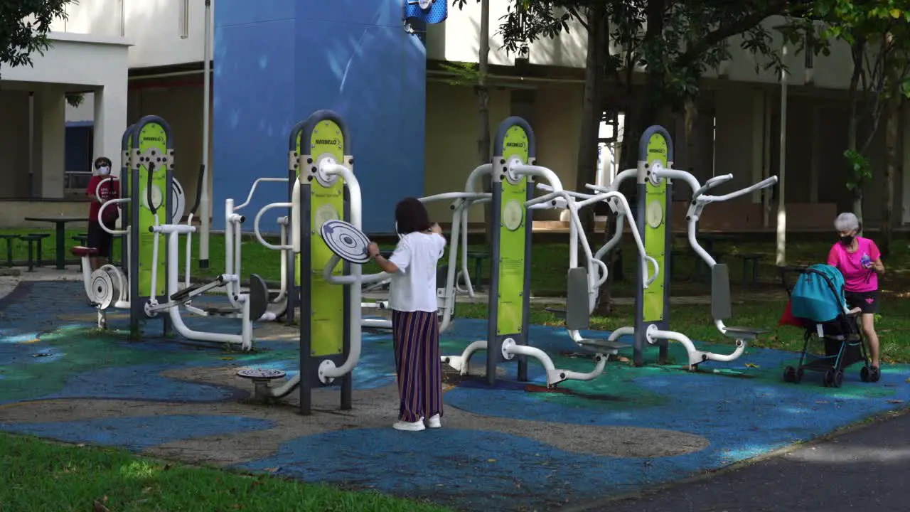 Multi generation group at a fitness corner open air exercise at HDB estate