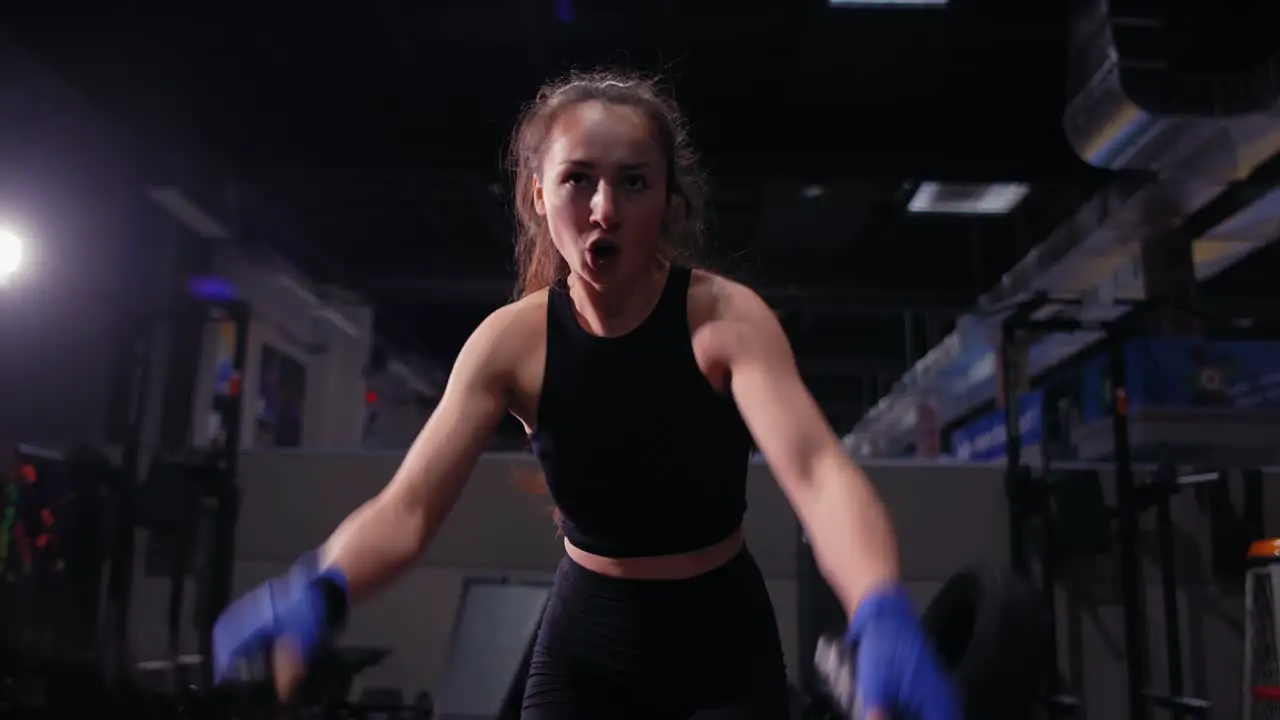 Athletic Young Woman Doing Some Crossfit Exercises With A Rope Indoor