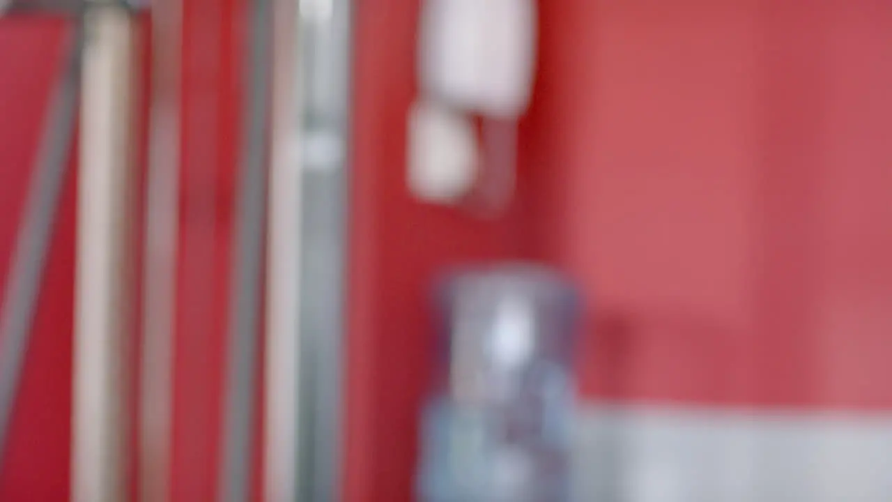 Fit African American man at the gym lifting weights with copy space