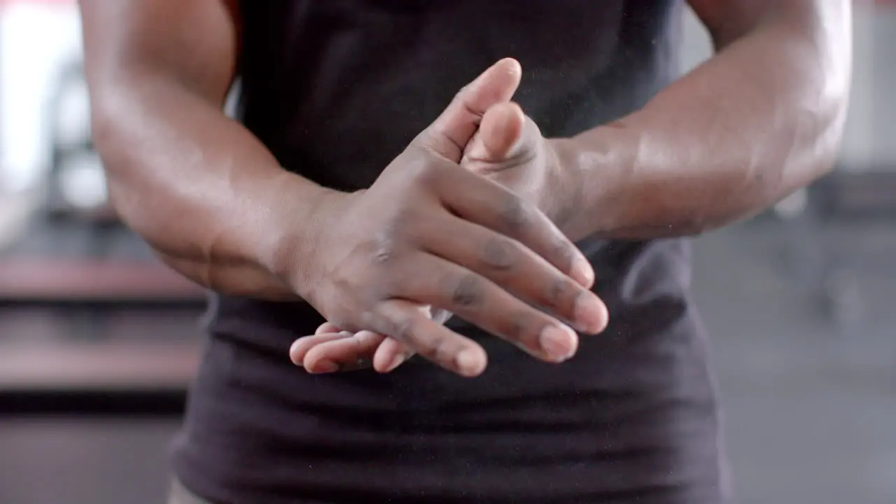 Fit African American man stretches his hands before a workout