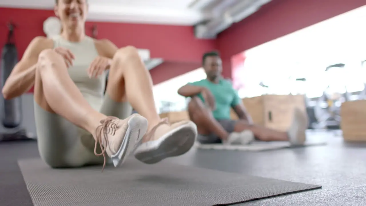 Fit diverse couple exercising at the gym