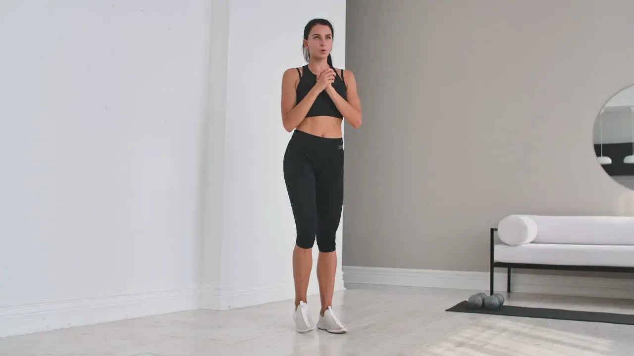 Beautiful Fit Girl Doing Home Workout Performing Lateral Lunges In A Sitting Room