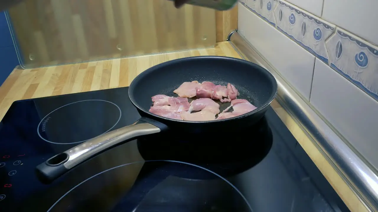 pouring salt on some chicken drumsticks fillets