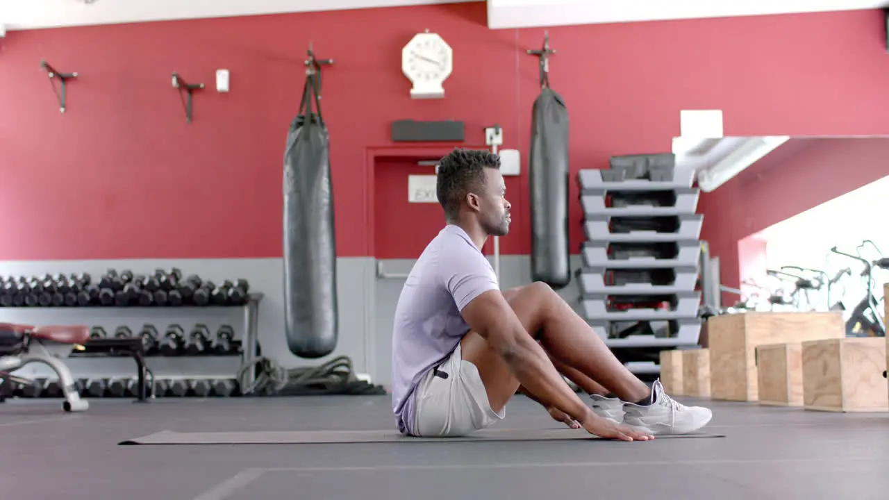 Fit African American man performs a workout at the gym