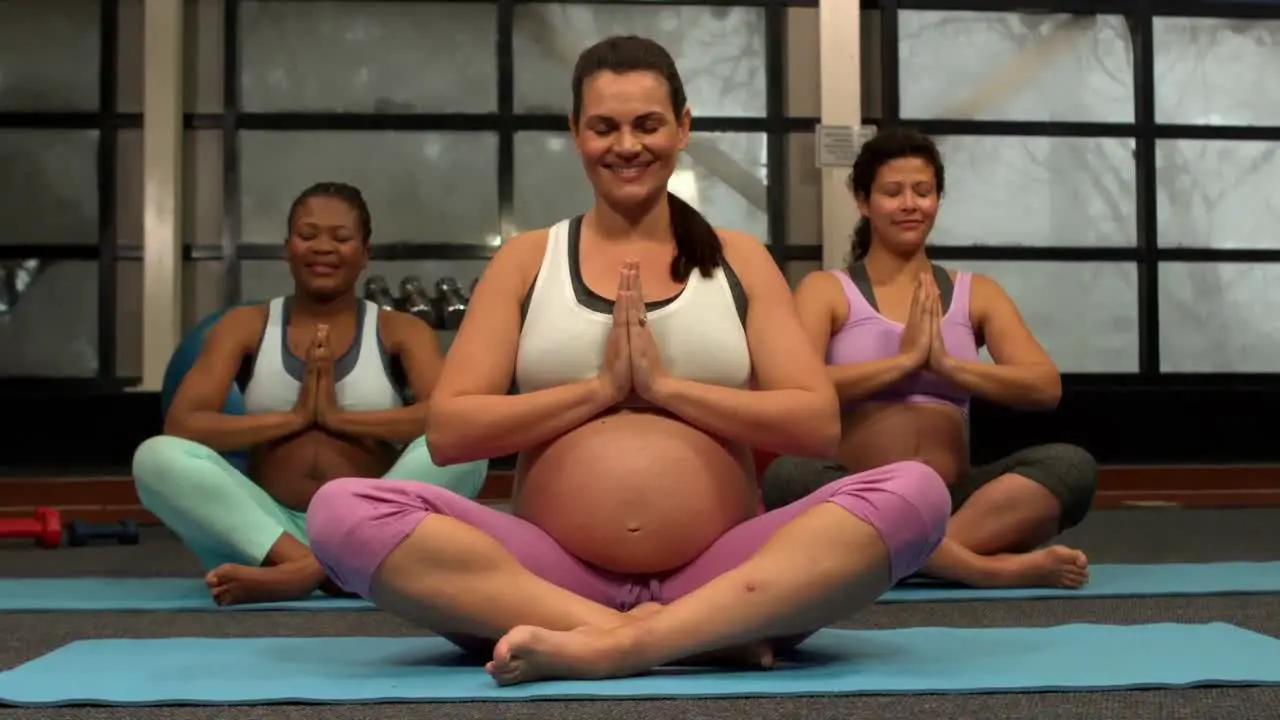 Pregnant women doing yoga at the gym