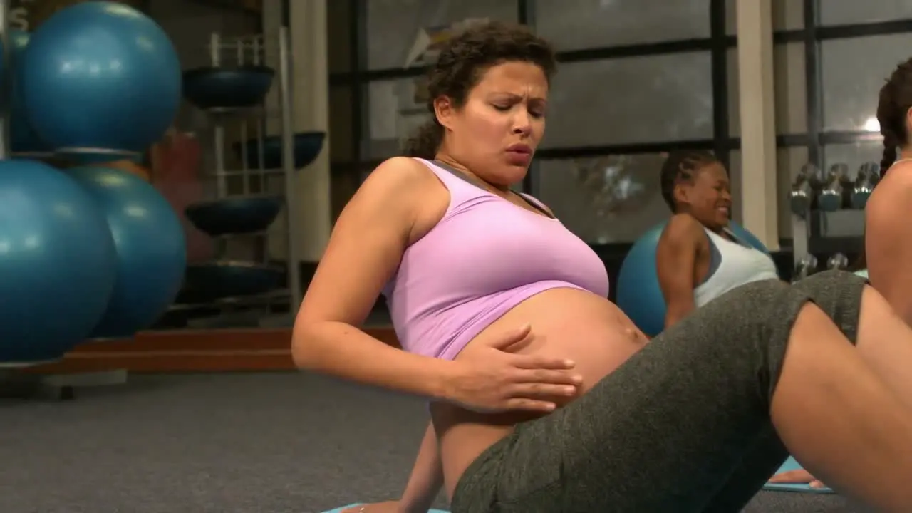 Pregnant women exercising at the gym