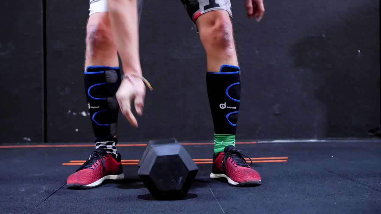 Captivating CrossFit Competition White Male Athlete Performing Snatches in a CrossFit Gym with Camera Tracking the Barbell