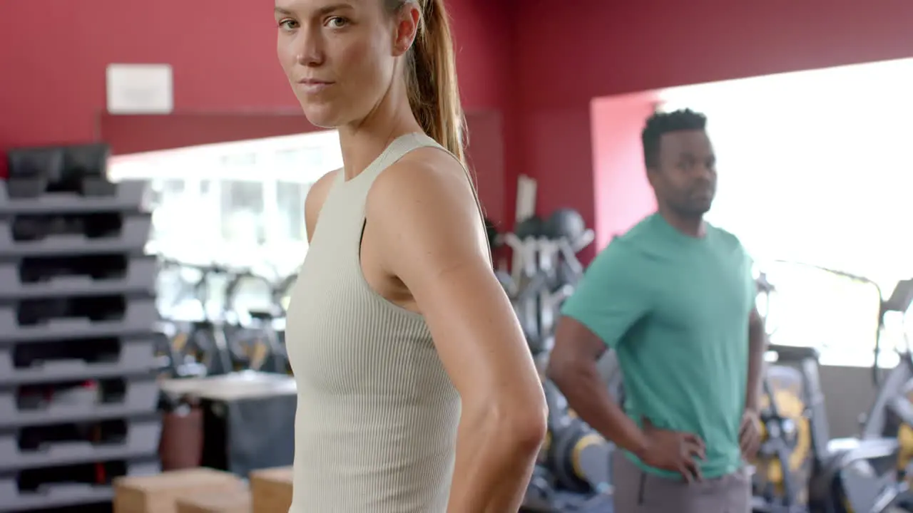 Fit young Caucasian woman and African American man at the gym