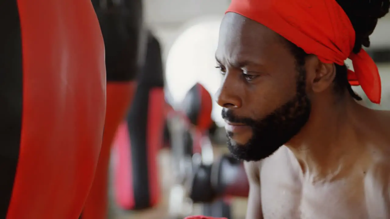 Male boxer practicing boxing in fitness studio 4k