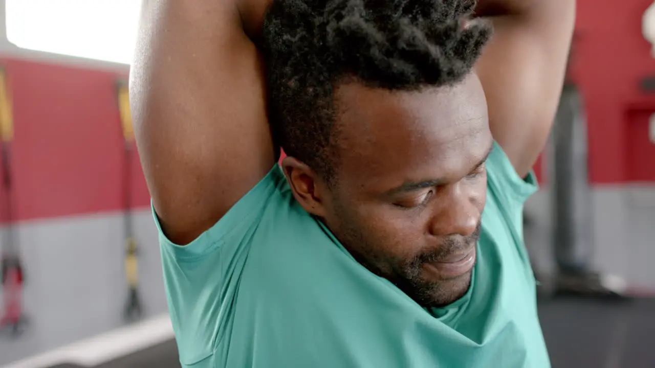 Fit African American man stretching at the gym