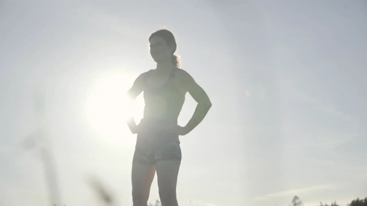 SLOMO of Young Woman Resting After a Run at Sunset